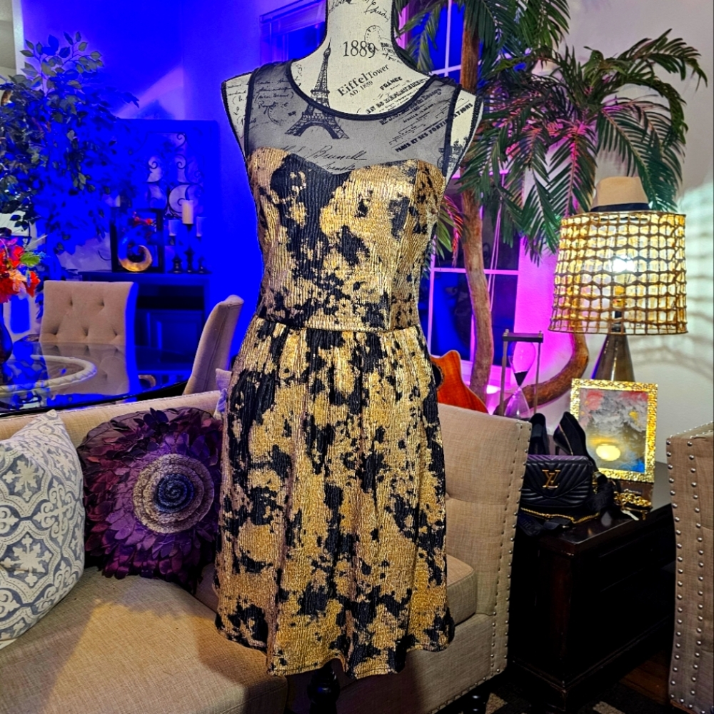 Black and gold short dress featuring a captivating sheer mesh sweetheart necklin